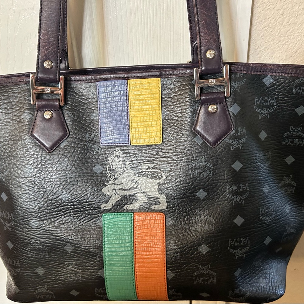 100% Authentic MCM lion tote. Few minor stains inside as seen in photos.